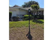 Traditional one story home featuring manicured lawn and manicured hedges at 9012 Sw 91St Cir, Ocala, FL 34481
