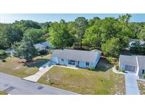 Charming single-story home with well-maintained lawn and mature trees in a quiet neighborhood setting at 9058 Sw 108Th Pl, Ocala, FL 34481