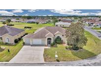 Inviting single-story home with a well-manicured lawn and a two-car garage in a serene neighborhood at 2369 Nw 53Rd Avenue Road, Ocala, FL 34482