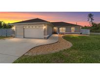 Charming single-story home featuring a two-car garage, landscaped yard and a concrete driveway at 2689 Sw 165Th Street Rd, Ocala, FL 34473