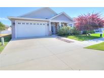 Charming one-story home with a two-car garage, attractive landscaping, and a well-maintained lawn at 4763 Se 25Th Loop, Ocala, FL 34480