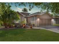 Beautiful home with a two-car garage, stone accents, mature landscaping, and a well-maintained lawn at 7167 Sw 99Th Cir, Ocala, FL 34481