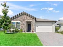Charming one-story home featuring a stone facade and well-maintained landscaping at 3840 Se 6Th Ave, Ocala, FL 34480