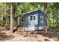 Charming single-story home featuring gray wood siding and a newly built wooden staircase at 6840 Sw 198Th Ave, Dunnellon, FL 34431