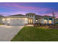 Charming single-story home features a three-car garage, well-manicured lawn, and covered entryway at 8497 Sw 99Th Cir, Ocala, FL 34481