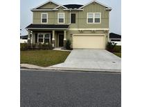 Two-story home featuring a two-car garage, neutral color palette, and well-maintained landscaping at 9326 Sw 57Th Ter, Ocala, FL 34476