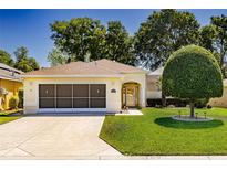 Charming single-story home featuring a well-maintained lawn, attached garage and manicured landscaping at 16299 Sw 14Th Avenue Rd, Ocala, FL 34473