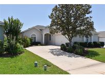 Charming single-story home with well-manicured landscaping and a spacious driveway leading to a two-car garage at 2339 Nw 55Th Avenue Rd, Ocala, FL 34482