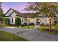 Charming single-story home boasts a meticulously landscaped yard and inviting curb appeal, enhanced by a well-lit walkway at 4083 Se 38Th Loop, Ocala, FL 34480