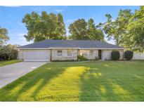 Charming single-story home with a well-manicured lawn and mature trees, offering great curb appeal at 8215 Sw 53Rd Ct, Ocala, FL 34476