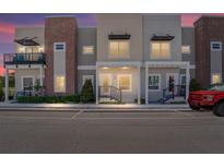 Charming townhouse exterior with modern architectural details, muted color palette, and manicured landscaping at 288 N Oak Ave, Sanford, FL 32771