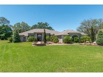 Expansive home features a well-manicured lawn, mature trees, and a circular driveway leading to a grand entrance at 5090 Nw 80Th Avenue Rd, Ocala, FL 34482
