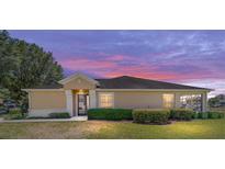 Charming single-story home featuring manicured landscaping and a well-maintained lawn at 9591 Sw 70Th Loop, Ocala, FL 34481