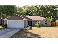 Charming single-story home featuring a well-maintained lawn, attached garage, and neutral color palette at 10 Banyan Track Way, Ocala, FL 34472