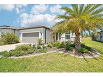 Charming single-story home with well-manicured lawn, lush landscaping, and a two-car garage at 8875 Sw 58Th Street Rd, Ocala, FL 34481