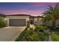 Charming single-story home boasts lush landscaping, a two-car garage, and a welcoming front entrance at 8875 Sw 58Th Street Rd, Ocala, FL 34481