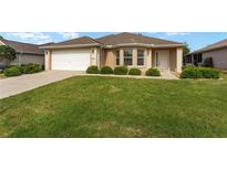 Charming single Gathering home featuring a well manicured lawn and attached two car garage at 9175 Se 118Th Loop, Summerfield, FL 34491