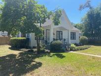 Charming home featuring well-manicured lawn, mature trees, and classic architectural design at 942 Ne 5Th St, Ocala, FL 34470