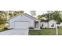 Charming one-story home with attached garage, manicured lawn, and inviting curb appeal at 9525 Sw 53Rd Cir, Ocala, FL 34476