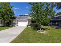 Charming single story home featuring a two-car garage, manicured lawn, and inviting front entrance at 9638 Sw 94Th Ave # C, Ocala, FL 34481