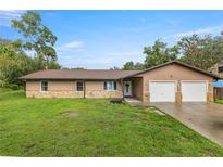 Charming single-story home with a two car garage and well-manicured lawn at 1081 Se 170Th Ave, Silver Springs, FL 34488