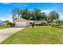 Charming single-story home with a well-manicured lawn and mature trees at 10833 Sw 86Th Ter, Ocala, FL 34481
