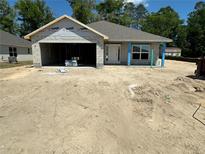 Unfinished single-story home with a two-car garage awaiting completion in a construction phase at 3107 Ne 46Th Ave, Ocala, FL 34470