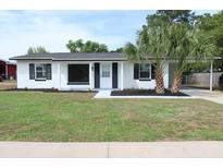 Charming single-story home with a well-manicured lawn, complemented by fresh plantings and black shutters at 3807 Sw 143Rd Lane Rd, Ocala, FL 34473