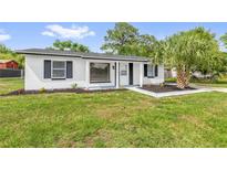 Charming single-story home featuring a fresh white exterior, black shutters, and a well-manicured lawn at 3807 Sw 143Rd Lane Rd, Ocala, FL 34473