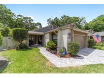 Charming single-story home featuring a manicured lawn, neutral color palette, and a brick-paved driveway at 4404 Ne 4Th St, Ocala, FL 34470