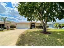 Well-maintained single Gathering home featuring a lush green lawn and mature landscaping at 15782 Sw 16Th Avenue Rd, Ocala, FL 34473