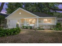 Charming single-story home features lush landscaping, covered porch with seating, and an attached garage at 9726 Sw 94Th Ter # C, Ocala, FL 34481