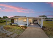 Charming single-story home with covered parking, manicured landscaping, and tranquil surroundings at dusk at 10197 Sw 88Th Ter, Ocala, FL 34481
