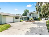Charming two-story home with a spacious driveway, well-maintained landscaping, and a detached two-car garage at 4237 Chambers St, Lake Wales, FL 33898