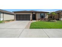Charming single-story home featuring a well-manicured lawn, neutral paint, and a two car garage at 6376 Sw 97Th Terrace Rd, Ocala, FL 34481