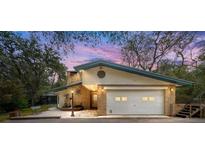 Charming single story home featuring a brick exterior, two car garage, and landscaped front yard at 1179 Se 170Th Ct, Silver Springs, FL 34488