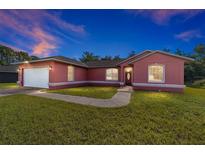 Charming single-Gathering home with a lush green lawn and a two-car garage at 15087 Sw 43Rd Ct, Ocala, FL 34473