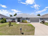 Charming single-story home with a well-manicured lawn, gray exterior, and inviting curb appeal at 4806 Nw 8Th Ter, Ocala, FL 34475