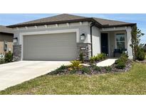 Charming single-Gathering home with a well-manicured lawn, stone accents, and a two-car garage at 5785 Sw 87Th Court Rd, Ocala, FL 34481