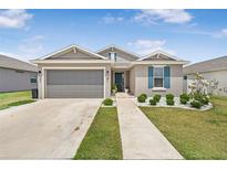 Charming single-story home with neutral exterior, two-car garage, and neatly manicured landscaping at 7571 Sw 64Th Street Rd, Ocala, FL 34474