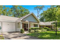 Charming home with a well-maintained front yard, covered porch, and a single-car garage at 8747 Sw 98Th Street Rd # F, Ocala, FL 34481
