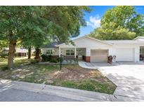 Charming single-story home featuring a well-kept lawn and attached one-car garage on a sunny day at 9855 Sw 85Th Terrace Rd # A, Ocala, FL 34481