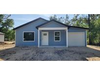 Charming single-story home with blue siding and attached one car garage at 1598 Sw 152Nd Ct, Ocala, FL 34481