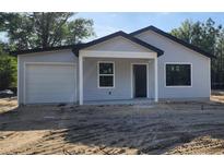 Charming single-story home featuring light gray siding and a covered front porch at 1610 Sw 152Nd Ct, Ocala, FL 34481