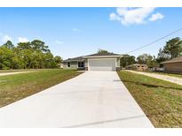 Charming single-story home with a spacious driveway and attached two-car garage at 2114 W Magenta Dr, Citrus Springs, FL 34434