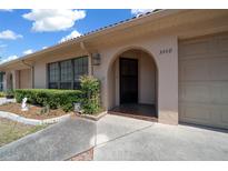 Charming home featuring an arched entryway, well-maintained landscaping, and convenient attached garage at 3449 Sw 19Th St, Ocala, FL 34474