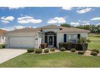 Charming single-story home with a well-manicured lawn and an attached two-car garage at 15691 Sw 11Th Court Rd, Ocala, FL 34473