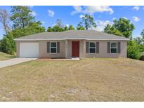 Charming single-story home featuring a front-facing garage and a well-maintained lawn at 17147 Sw 42Nd Ct, Ocala, FL 34473