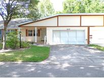 Charming single-story home featuring a well-manicured lawn and a two-car garage at 8653 Sw 95Th Ln # F, Ocala, FL 34481