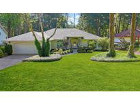 Charming one-story home boasts lush lawn, mature trees, and well-manicured landscaping at 9129 Sw 193Rd Cir, Dunnellon, FL 34432